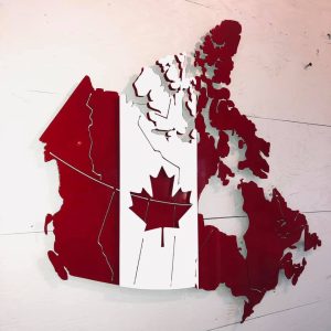 illustration of geographical boundaries of canada overlapped with red and white maple leaf flag